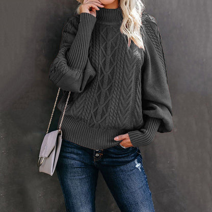 Women's chunky knit sweater with high collar and voluminous sleeves